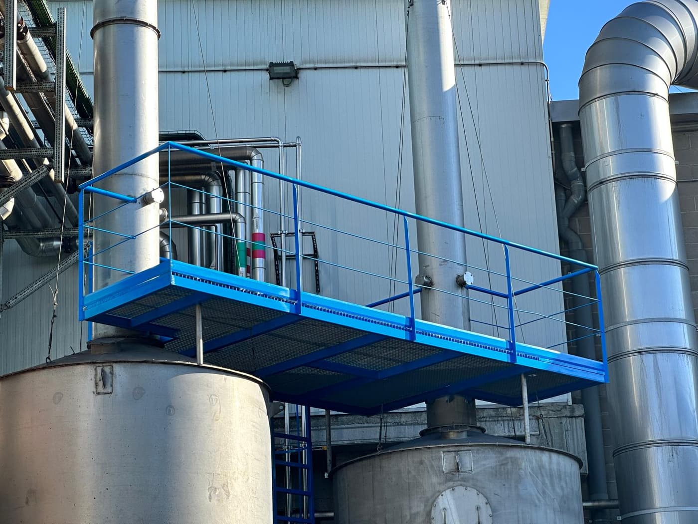 Pasarela y plataforma de acceso instalada sobre depósitos industriales